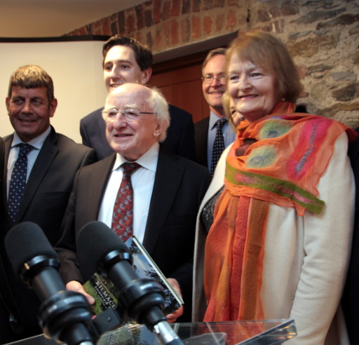 Megan presents her book to President Higgins